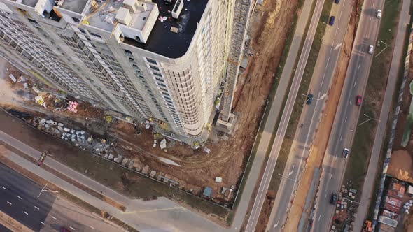 Aerial Top Down View Construction with Yellow Tower Crane Working on Building Site alt