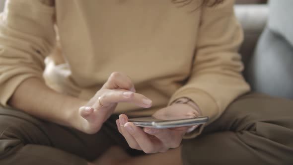 Woman Using Phone to Work From Home