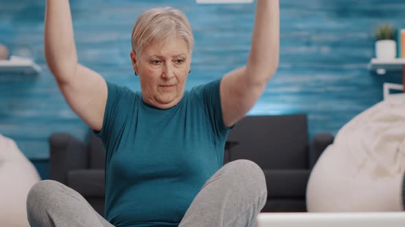 Close Up of Pensioner Training with Dumbbells on Yoga Mat alt