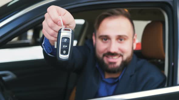 Closeup of Male Hand Holding Car Keys of New Vehicle
