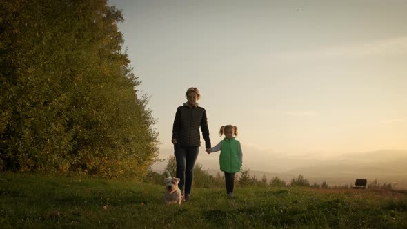 Woman with Little Daughter Walking the Dog in the Park Forest alt