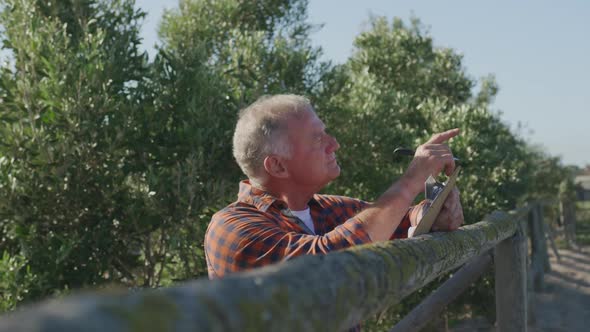 Mature man working on farm alt