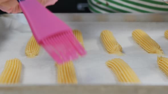 Brush the Eclairs Before Baking the Cocoa Butter with a Pink Silicone Brush