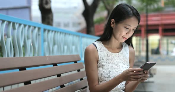 Woman using mobile phone in city  alt