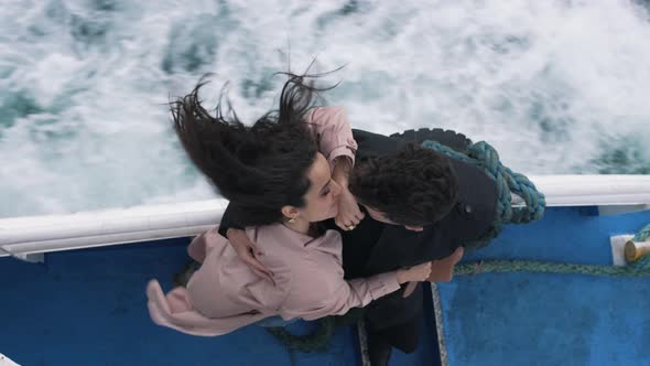 Couple Hugging While Riding a Boat