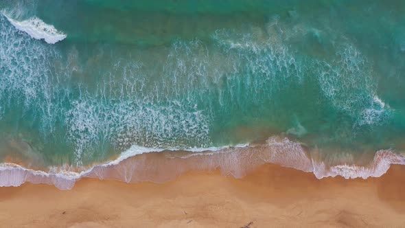Aerial Top View White Foamy Waves Crash Along The Beach alt