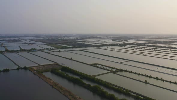 Aerial top view of natural sea salt ponds. Farm field outdoor. Material in traditional industry alt
