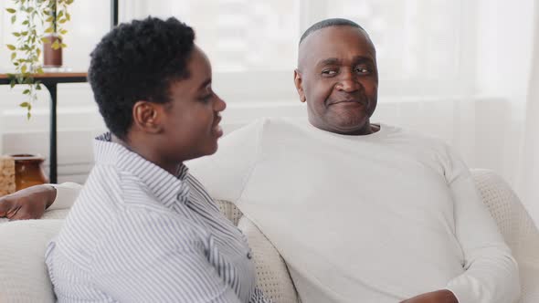 Family Conversation at Home Afro American Couple Husband and Wife Talking Sitting on Sofa Black alt