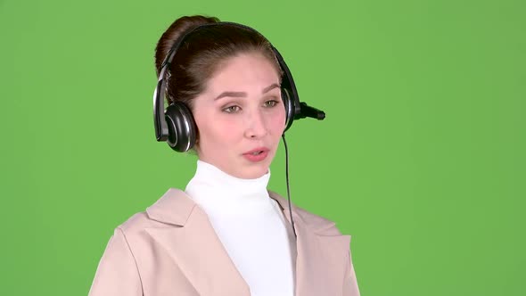 Manager in the Call Center Talks To the Customers on the Headset. Green Screen alt
