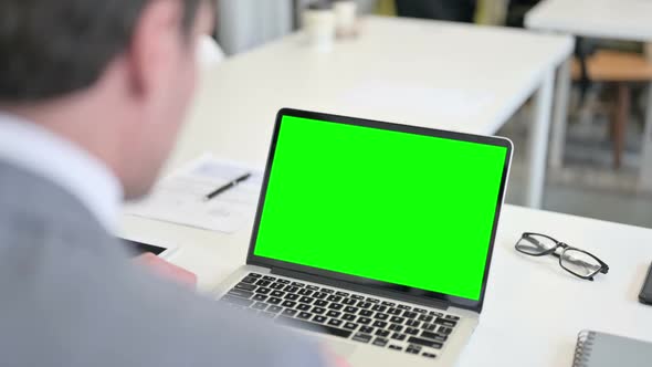 Businessman Using Laptop with Green Chroma Key Screen alt