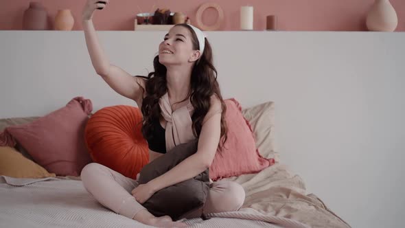Woman Take Lovely Selfie at Home in Cute Feminine Interior. Young Teen Blogger Makes Self Portrait