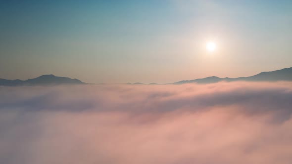 Hyper lapse Drone flight over the clouds during sunrise.