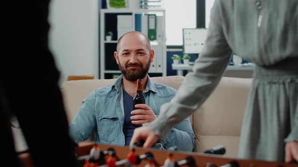 Portrait of Businessman Holding Bottle of Beer After Work alt