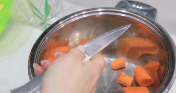 Carrots Cut Into a Saucepan