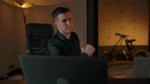 Young Male Composer Writes Music Using Laptop and Electronic Piano alt