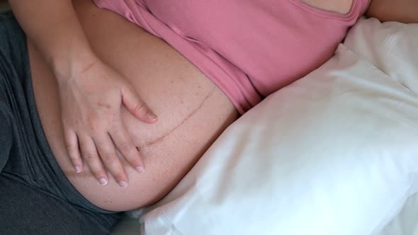 Happy Pregnant Woman and Expecting Baby at Home alt