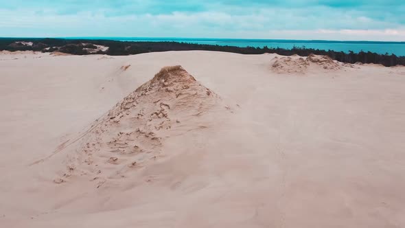 Sand dunes from drone. Amazing sea desert. Beautiful sky.