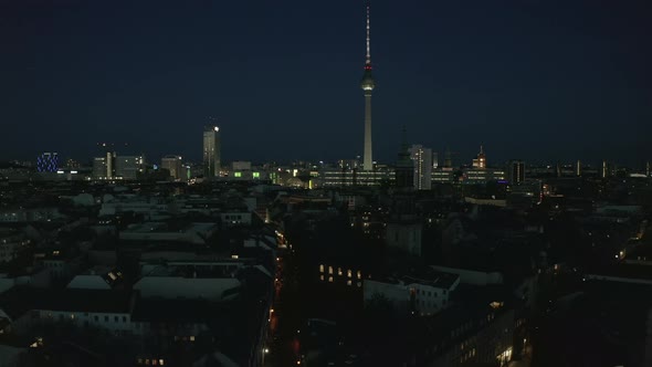 AERIAL View of Empty Berlin Germany Cityscape Skyline at Night with City Light During COVID 19 alt