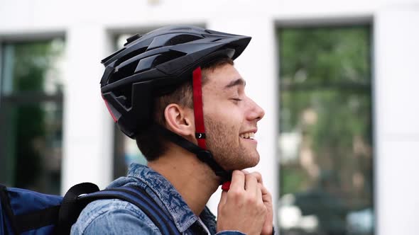 Closeup Face of Handsome Cheerful Young Courier Male with Large Thermo Backpack Taking Off alt