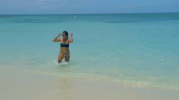 Woman Relaxing on the beachPalm Beach Aruba Caribbean White Long Sandy Beach with Palm Trees at alt