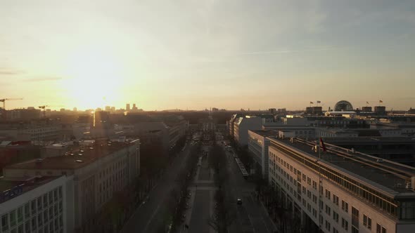 AERIAL: Scenic Low Flight Through Busy Berlin, Germany Street Towards Brandenburg Gate in Beautiful alt
