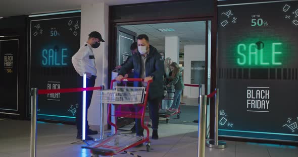 Guard Asking Customers To Disinfect Hands at Mall Entrance alt