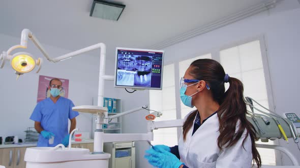 Dentist Doctor and Patient Looking at Digital Teeh Xray alt