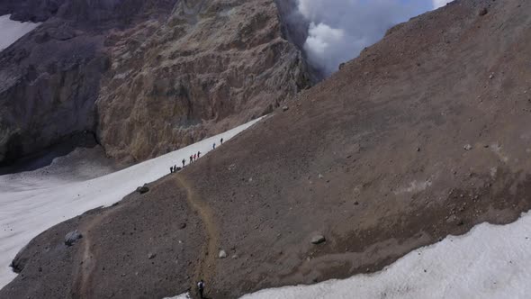 People Hiking on Mutnovsky Volcano Crater with Fumaroles and Glacier