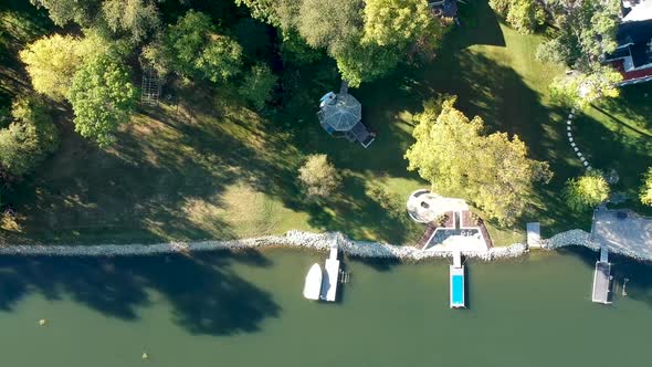 Lake Shore Drone Shot with Green Water and Boats