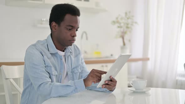 African Man Using Tablet at Home alt