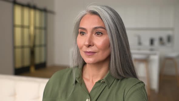 Headshot of Senior Dreaming Asian Ethnic Female with Beautiful Smile and Looking at Camera