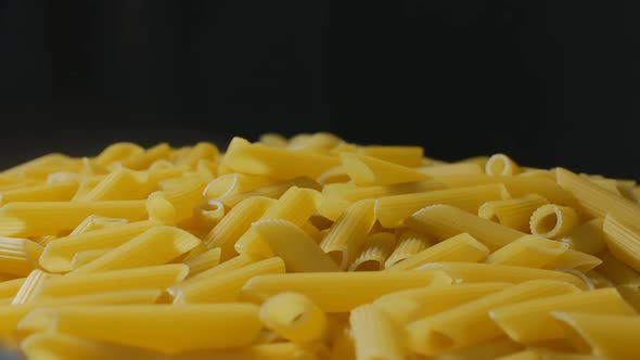 Closeup of a Lot of Penne Pasta Rotating