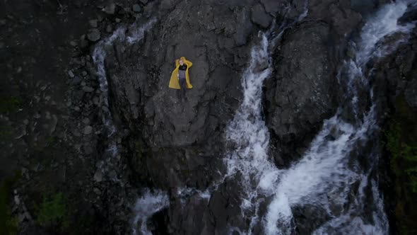 Top View Portrait of Beautiful Blond Woman Listen Music on Rock Near Waterfall