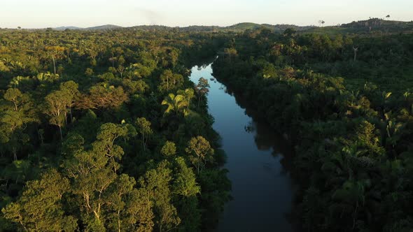 Drone Descends From The Top Of A River, In The Middle Of The Amazon Rainforest