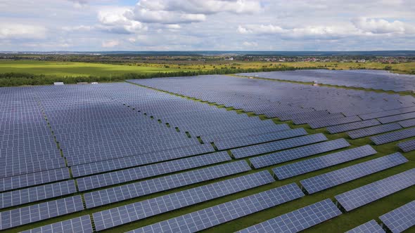 Aerial View of Big Sustainable Electric Power Plant with Many Rows of Solar Photovoltaic Panels for alt