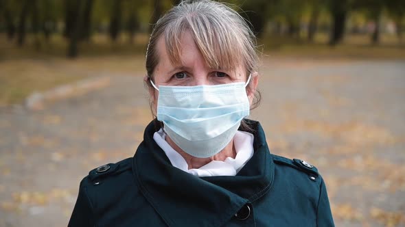Portrait of a Senior Woman in a Medical Protection Mask