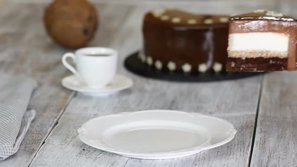Piece of Chocolate Mousse Cake with Coconut Filling on the Old Wooden Background. Mousse Cake with alt