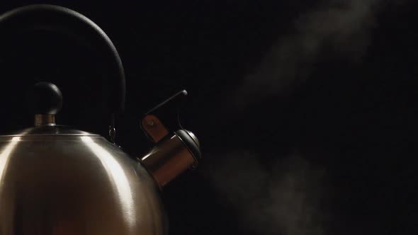 Close Up Of A Steam From A Steel Kettle On A Black Background