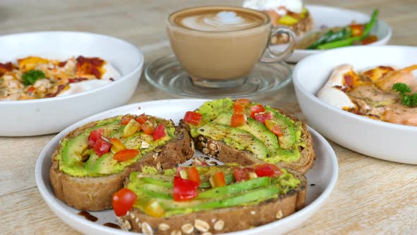Healthy Food in Cafe  Vegan Toast with Avocado and Tomato Fresh Seafood Pizzas alt