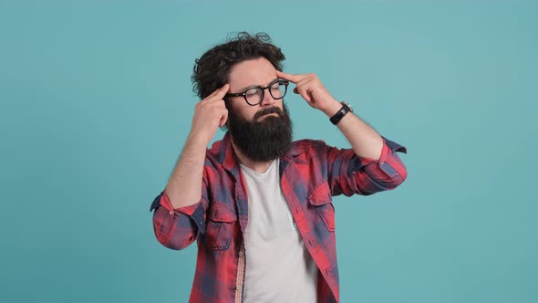 Close Up of an Exhausted Man, Suffering From a Headache Holding His Hands Behind Head alt