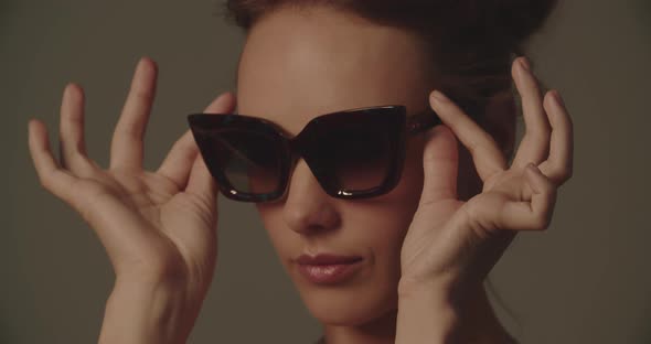 Beautiful Young Woman Trying On A Pair Of Sunglasses