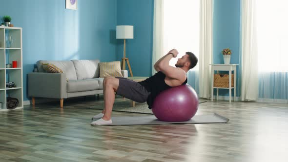 Man Is Doing Upper Crunches on Stability Ball alt
