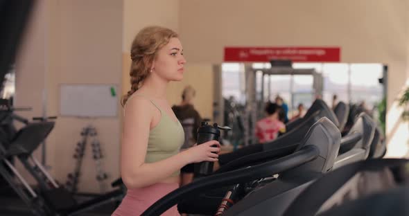 Woman Walking on a Treadmill in Gym