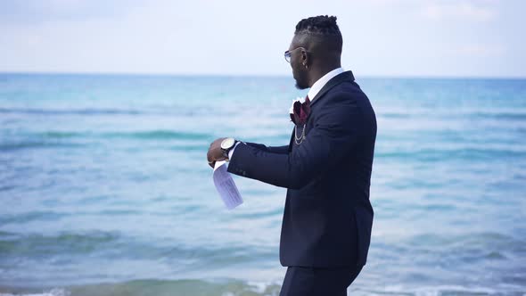 Troubled Nervous African American Businessman Tearing Documents Standing on Mediterranean Sea Coast alt