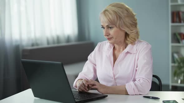 Aged Lady Actively Flirting and Chatting with Gentlemen on Dating Website alt