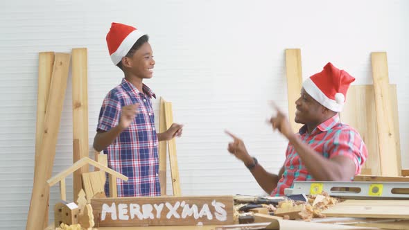 Christmas happy, Cheerful african american son carpenter dancing moves to happy with father happily  alt