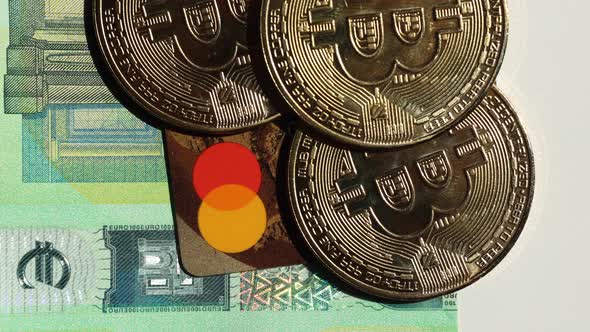 Golden Bitcoins Place on Credit Cards Under Euro Banknotes alt
