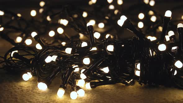 Closeup Shot Hank of Christmas Garland with Golden Lights on a Playd alt