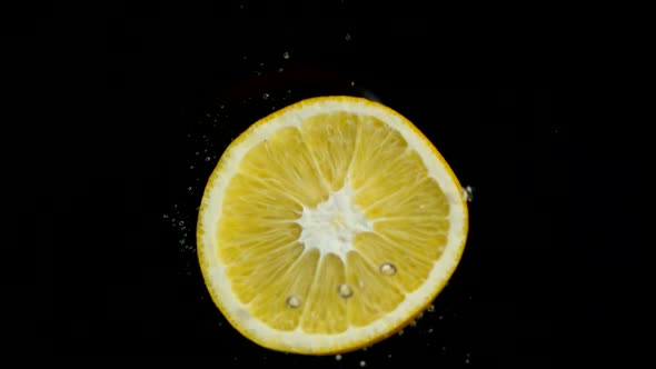The Circle of an Orange Falls Into the Water
