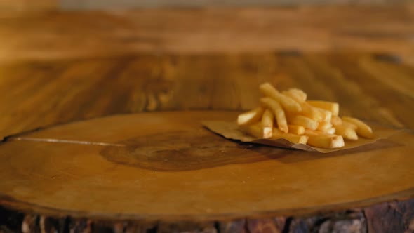 Hands in Gloves Put a Juicy Black Burger with Big Cutlets and Vegetables on the Wooden Board